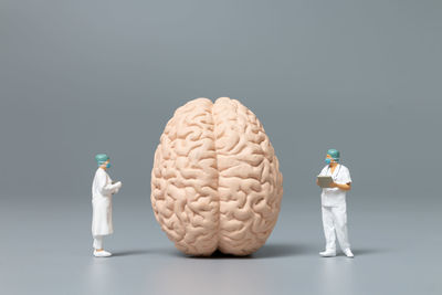 Stack of figurine on table against gray background