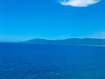 Scenic view of sea against blue sky