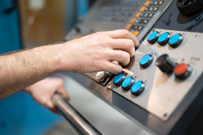 Cropped hands of man using sound mixer