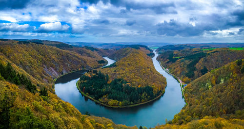 Aerial view of river amidst landscape against sky