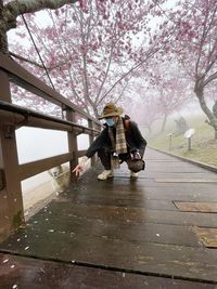 Rear view of woman walking on footpath