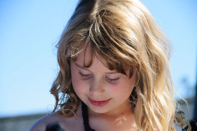 Close-up of young woman against clear sky