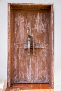 Old wood door on white wall
