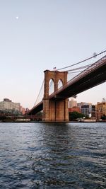 Bridge over river with buildings in background