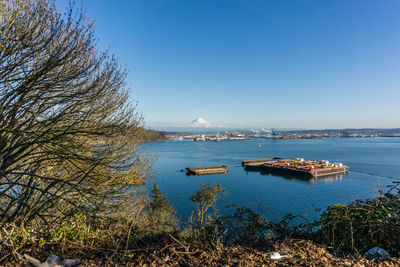 A view of the port of tacoma with mount rainier in the distance.