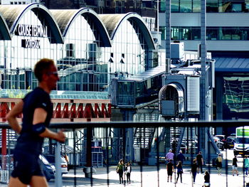 People walking on bridge in city