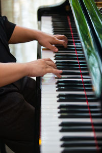 Close-up of hands playing the piano