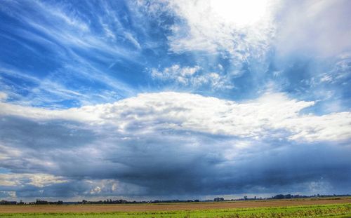 Scenic view of landscape against cloudy sky
