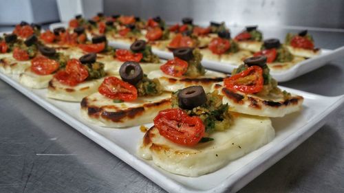 Close-up of canapes in trays on table