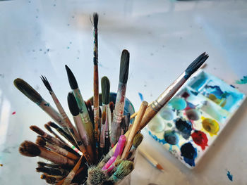 Close-up of paintbrushes and palette on table