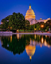 Reflection of trees in lake at night, congress building 