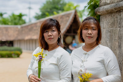 Portrait of women holding flowers