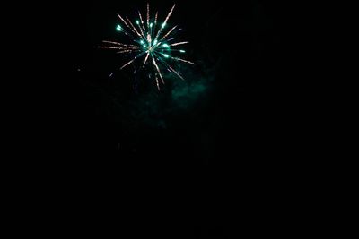 Low angle view of firework display at night