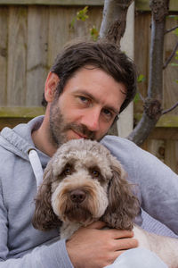 Portrait of man with cockapoo dog