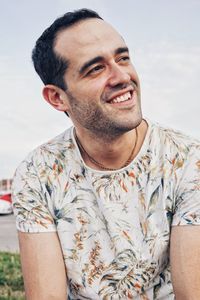 Portrait of young man against sky