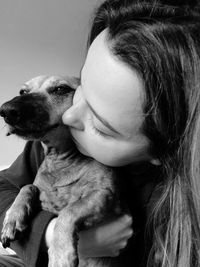 Close-up of woman kissing dog