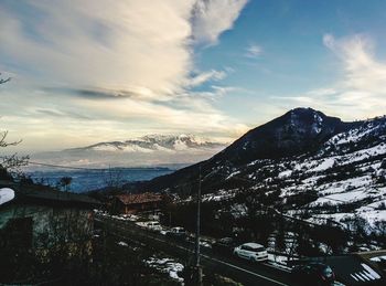 Scenic view of snow covered mountains against sky