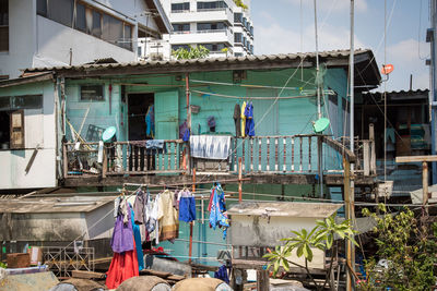 Clothes drying against buildings in city