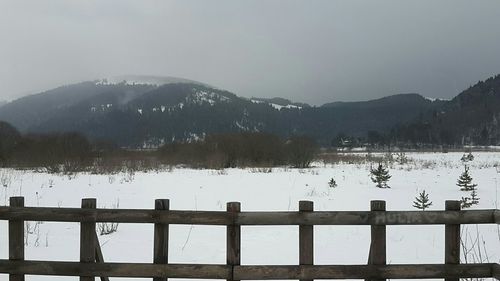 Scenic view of lake against sky during winter