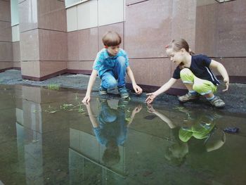 Side view of girl standing in water