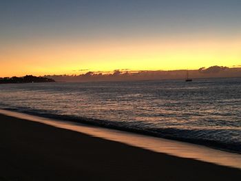 Scenic view of sea against romantic sky at sunset