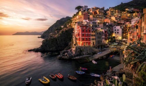 High angle view of buildings in sea during sunset