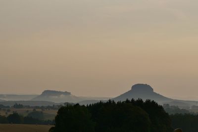 Scenic view of silhouette mountains against sky at sunset