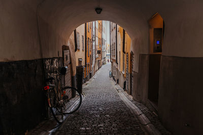 Empty alley amidst buildings in city