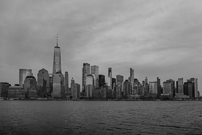 Modern buildings in city against cloudy sky