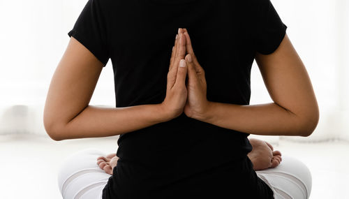 Midsection of woman sitting on floor