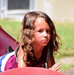 Portrait of cute girl playing on outdoor play equipment