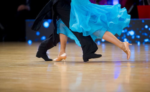 Low section of couple dancing on floor