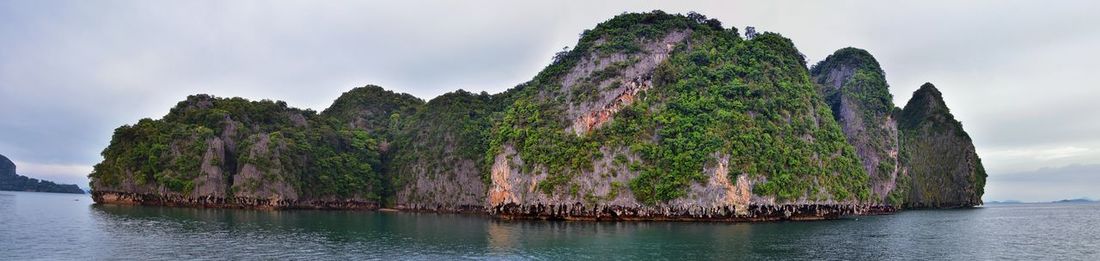 Panoramic view of rocks in sea against sky