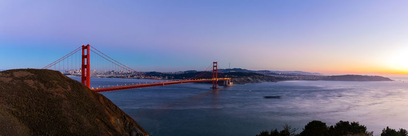 View of suspension bridge at sunset