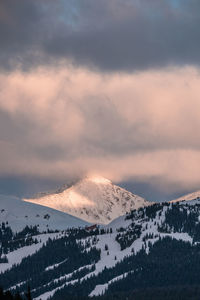 Scenic view of snowcapped mountains against sky during sunset