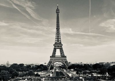 Tower of building against cloudy sky