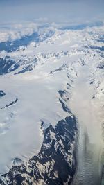 Aerial view of snowcapped mountains against sky