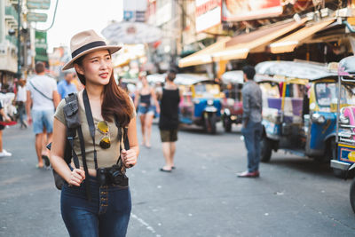 Full length of woman standing on street in city