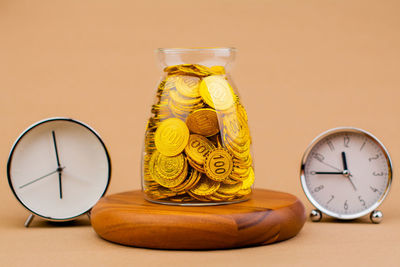 Close-up of coins in jars on table