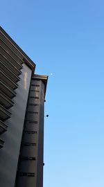 Low angle view of a building against clear blue sky