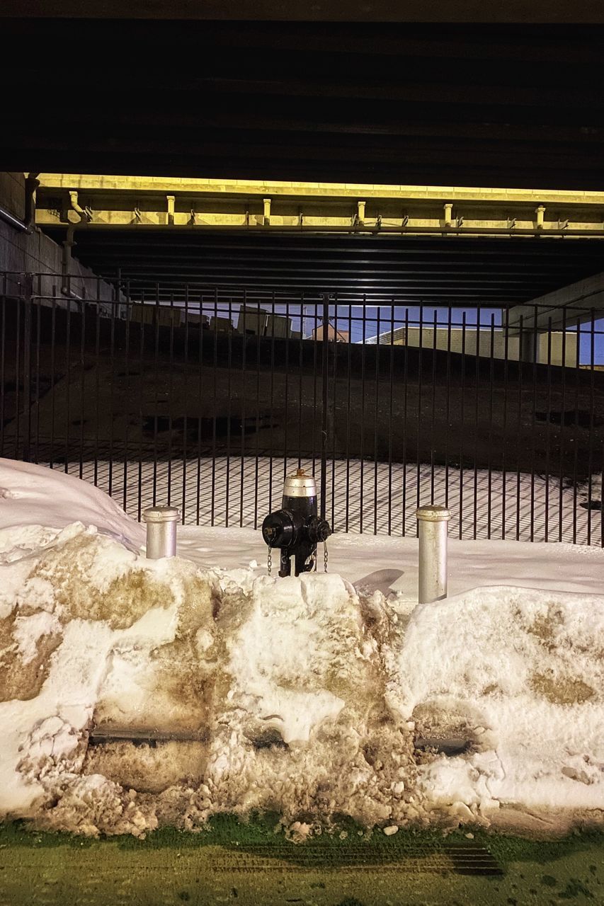 REAR VIEW OF MAN ON BRIDGE