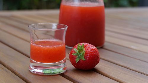 Close-up of strawberry with drink on table