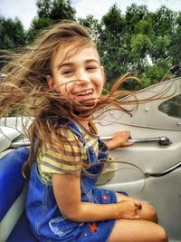 Portrait of smiling girl in car