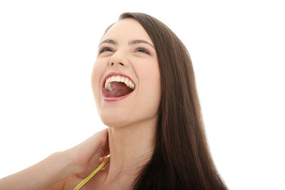 Close-up portrait of a young woman against white background