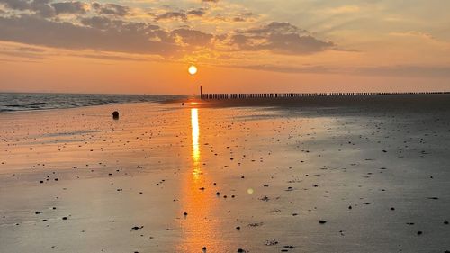 Scenic view of beach against sky during sunset