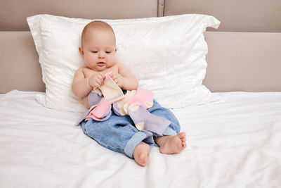 Portrait of cute baby boy sleeping on bed at home