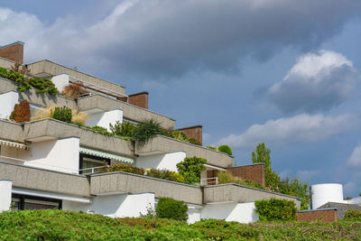 Low angle view of house and building against sky