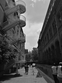 Man in city against sky