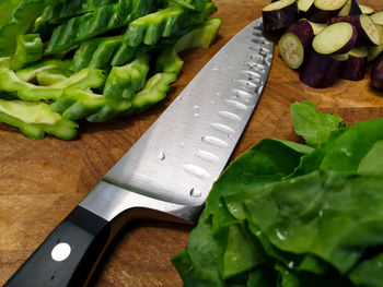 High angle view of chopped vegetables and a knife on a cutting board