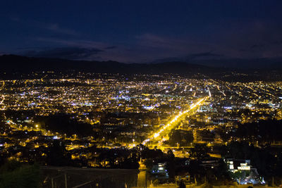 High angle view of illuminated buildings in city at night